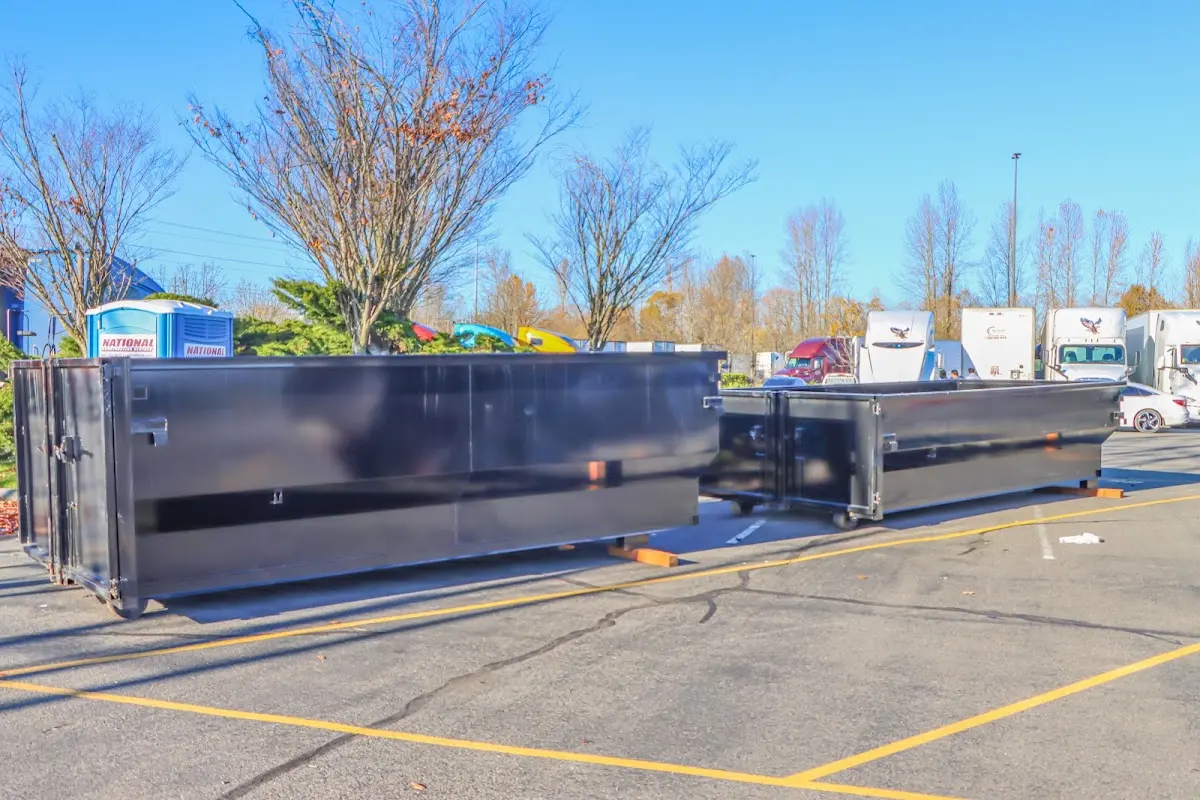 Professional dumpster rental service with roll-off container on residential driveway in Putnam Valley